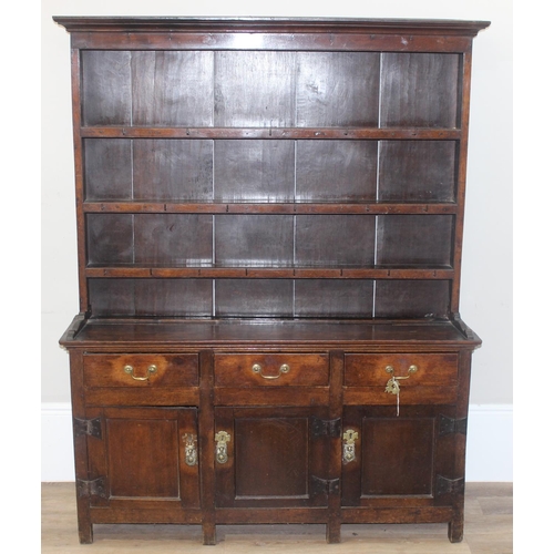 23 - An antique country oak dresser, likely 18th century, the base comprising of 3 cupboards under 3 draw... 