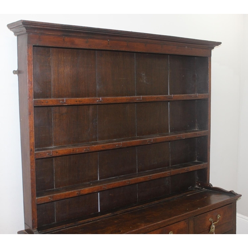 23 - An antique country oak dresser, likely 18th century, the base comprising of 3 cupboards under 3 draw... 