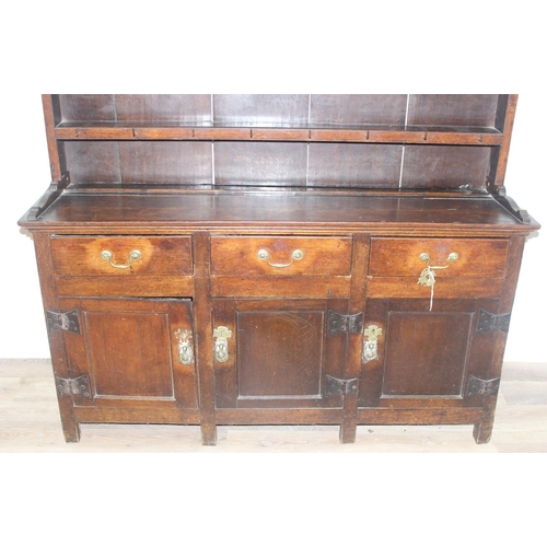 23 - An antique country oak dresser, likely 18th century, the base comprising of 3 cupboards under 3 draw... 