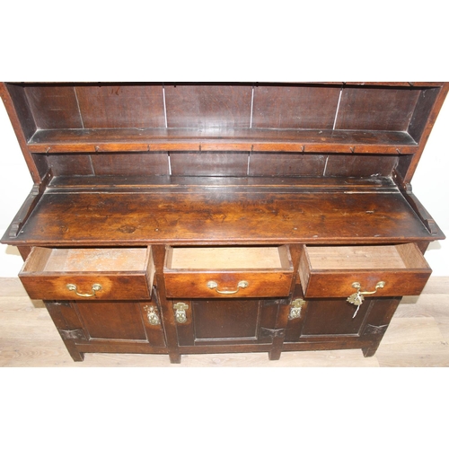 23 - An antique country oak dresser, likely 18th century, the base comprising of 3 cupboards under 3 draw... 