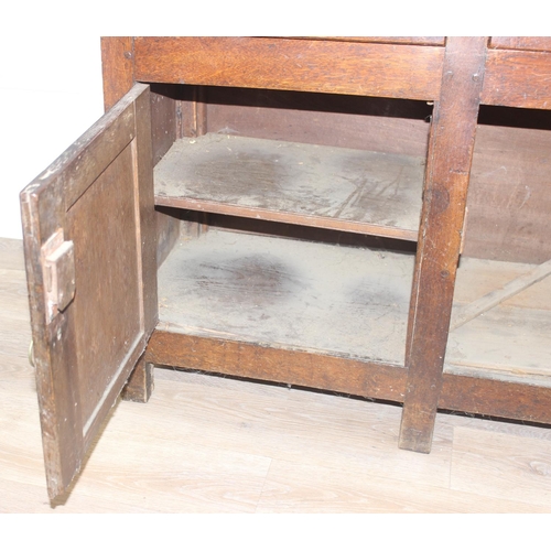 23 - An antique country oak dresser, likely 18th century, the base comprising of 3 cupboards under 3 draw... 