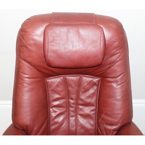 42 - A retro Ekornes style burgundy leather lazy boy armchair with splayed wooden base, approx 110cm tall