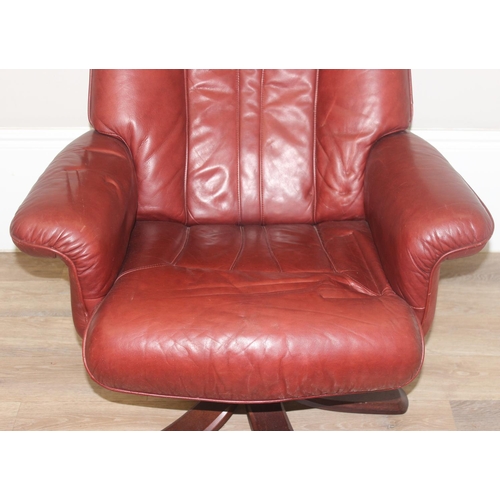 42 - A retro Ekornes style burgundy leather lazy boy armchair with splayed wooden base, approx 110cm tall