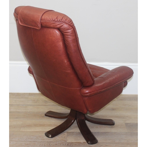 42 - A retro Ekornes style burgundy leather lazy boy armchair with splayed wooden base, approx 110cm tall