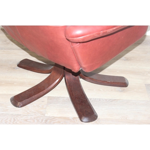 42 - A retro Ekornes style burgundy leather lazy boy armchair with splayed wooden base, approx 110cm tall