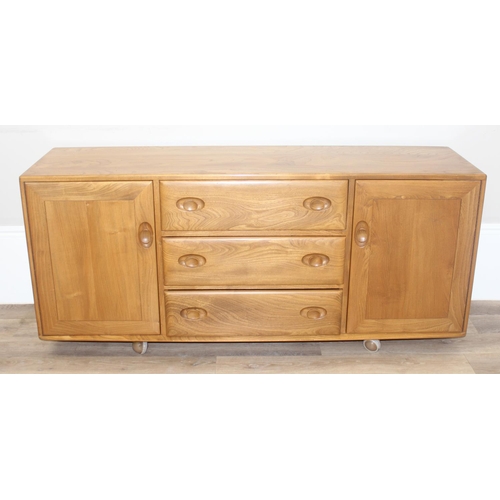 1 - A retro Ercol Windsor range 3 draw 2 cupboard sideboard, model 455 with cutlery tray, on wheels, blo... 