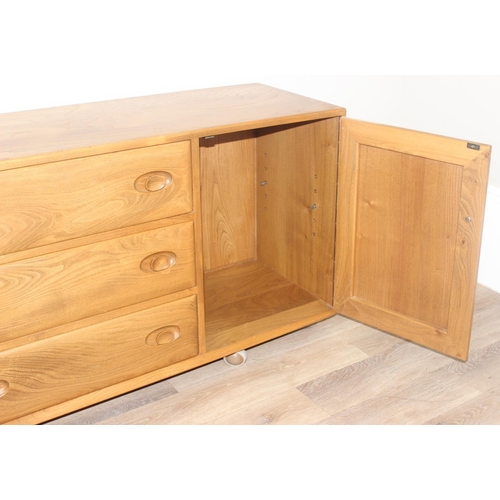 1 - A retro Ercol Windsor range 3 draw 2 cupboard sideboard, model 455 with cutlery tray, on wheels, blo... 