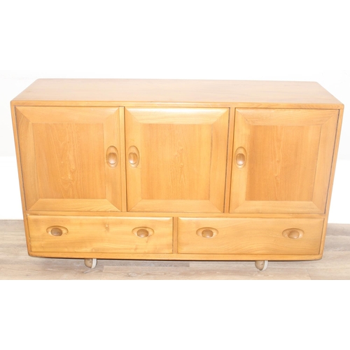 2 - A retro Ercol Windsor range 3 cupboard over 2 draw sideboard, design number 905093, on wheels, blond... 