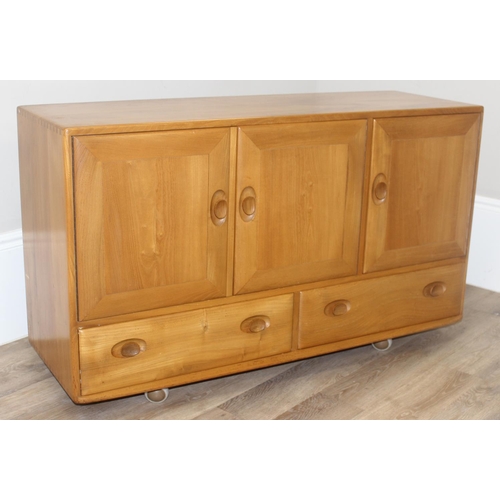 2 - A retro Ercol Windsor range 3 cupboard over 2 draw sideboard, design number 905093, on wheels, blond... 