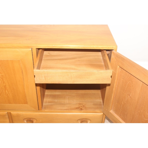 2 - A retro Ercol Windsor range 3 cupboard over 2 draw sideboard, design number 905093, on wheels, blond... 