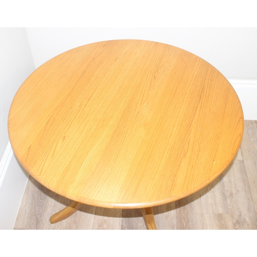 4 - A retro Ercol circular dining table, design number 1116, on 4 legged pedestal base, blonde finish, a... 