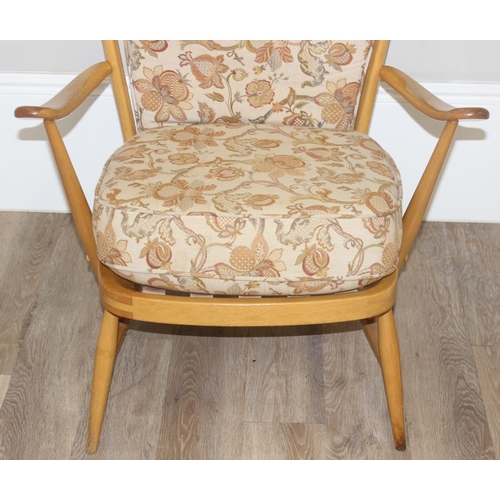 8 - Ercol blonde high back lounge chair with floral designed cushions, approx 115cm tall