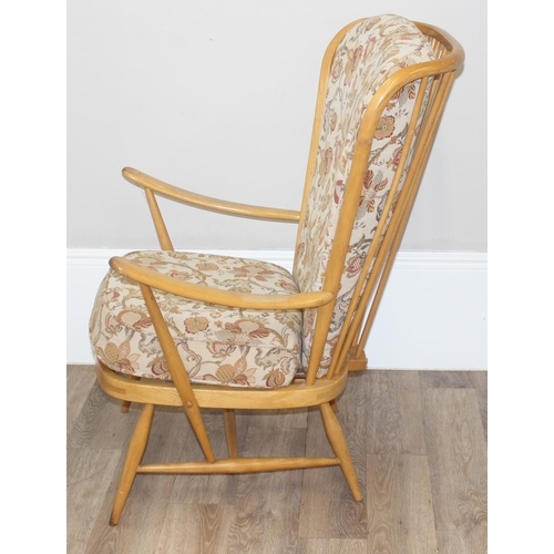 8 - Ercol blonde high back lounge chair with floral designed cushions, approx 115cm tall