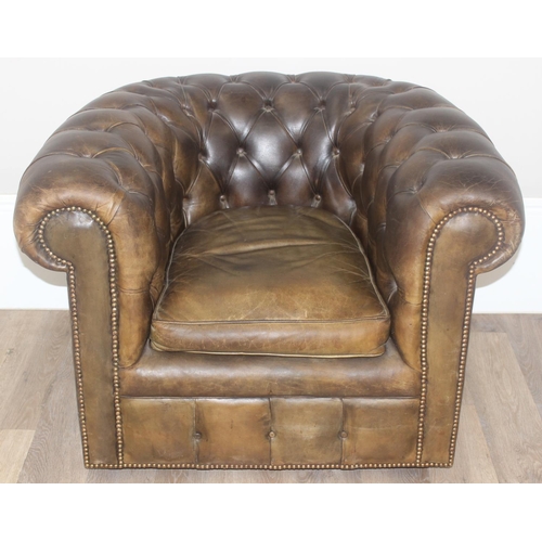 12 - A Chesterfield style leather club chair to match the sofa in the previous lot, distressed brown/ gre... 