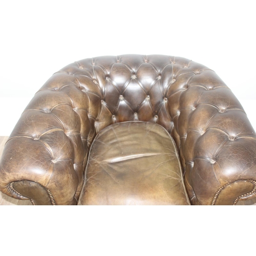 12 - A Chesterfield style leather club chair to match the sofa in the previous lot, distressed brown/ gre... 