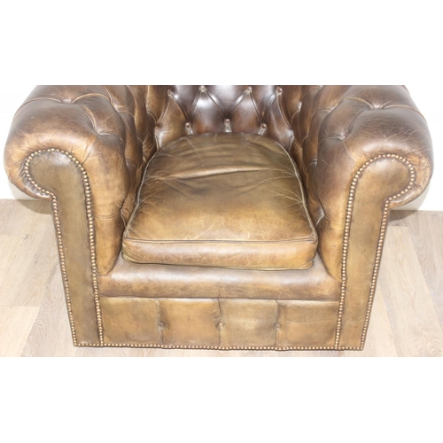 12 - A Chesterfield style leather club chair to match the sofa in the previous lot, distressed brown/ gre... 