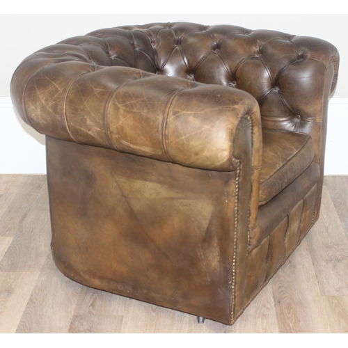 12 - A Chesterfield style leather club chair to match the sofa in the previous lot, distressed brown/ gre... 