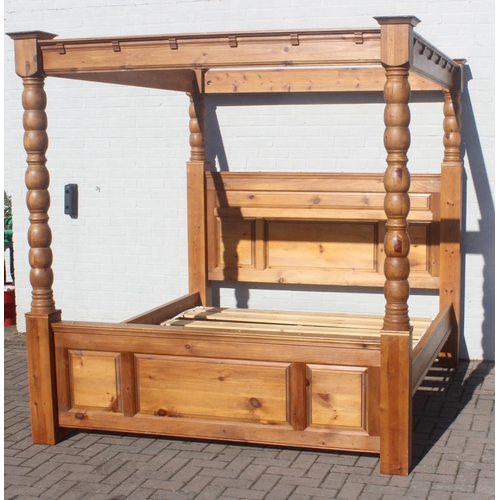 25 - A vintage pine 4 poster bed frame to fit a Super King size mattress, the frame approx 215cm tall