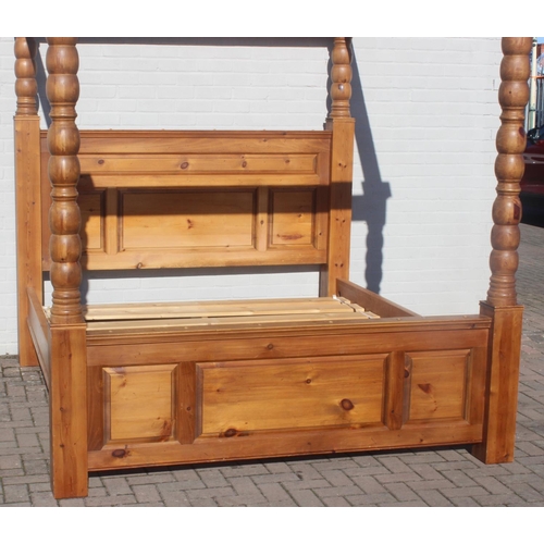 25 - A vintage pine 4 poster bed frame to fit a Super King size mattress, the frame approx 215cm tall