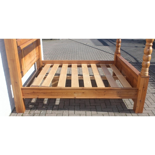 25 - A vintage pine 4 poster bed frame to fit a Super King size mattress, the frame approx 215cm tall