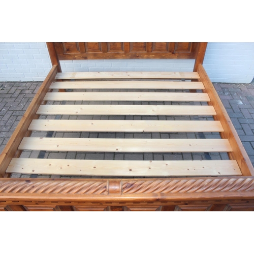 26 - A rustic panelled pin bed frame with twisted decoration, to fit a king size mattress, approx 128cm t... 