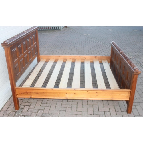 26 - A rustic panelled pin bed frame with twisted decoration, to fit a king size mattress, approx 128cm t... 