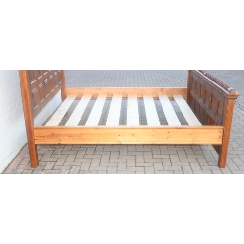 26 - A rustic panelled pin bed frame with twisted decoration, to fit a king size mattress, approx 128cm t... 