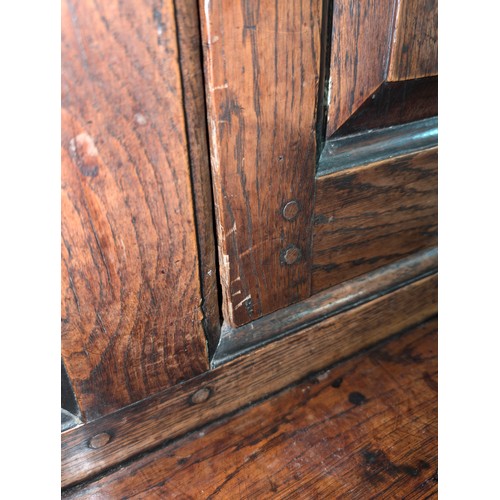 16 - An 18th century oak court cupboard with Georgian brass handles, dated 1754 and believed to be of tha... 