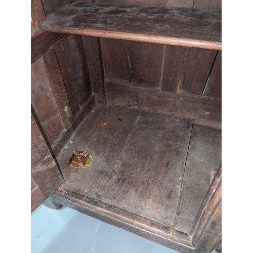 16 - An 18th century oak court cupboard with Georgian brass handles, dated 1754 and believed to be of tha... 