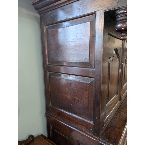 16 - An 18th century oak court cupboard with Georgian brass handles, dated 1754 and believed to be of tha... 