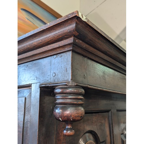 16 - An 18th century oak court cupboard with Georgian brass handles, dated 1754 and believed to be of tha... 