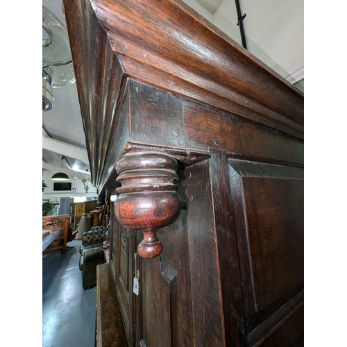 16 - An 18th century oak court cupboard with Georgian brass handles, dated 1754 and believed to be of tha... 