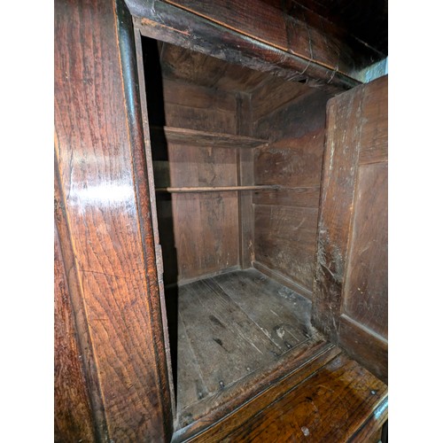 16 - An 18th century oak court cupboard with Georgian brass handles, dated 1754 and believed to be of tha... 