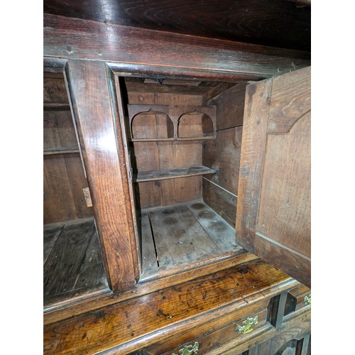 16 - An 18th century oak court cupboard with Georgian brass handles, dated 1754 and believed to be of tha... 