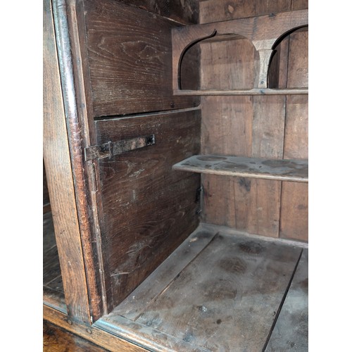 16 - An 18th century oak court cupboard with Georgian brass handles, dated 1754 and believed to be of tha... 