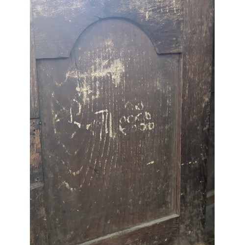 16 - An 18th century oak court cupboard with Georgian brass handles, dated 1754 and believed to be of tha... 