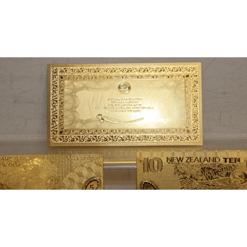 1215 - A set of New Zealand Polymer gold coloured banknotes, in display folder, denominations from $5 to $1... 