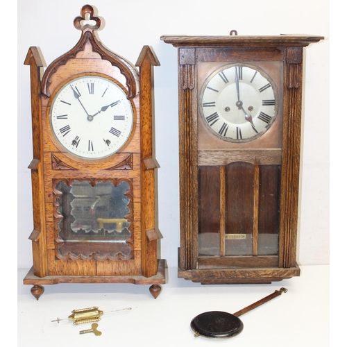 1309 - 2 vintage oak wall clocks, one in Gothic Revival style case, both with pendulums, the largest approx... 