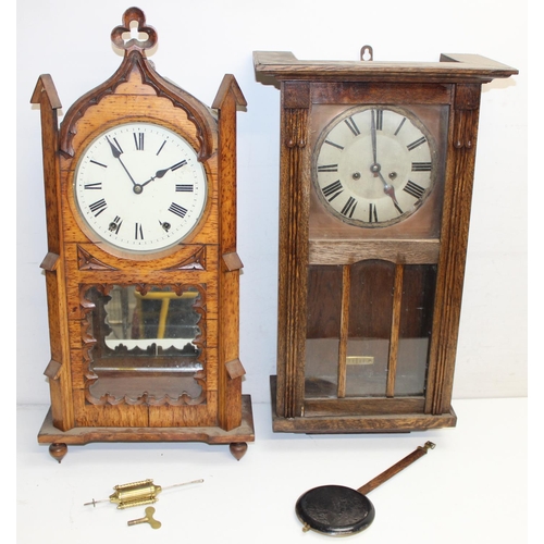 1309 - 2 vintage oak wall clocks, one in Gothic Revival style case, both with pendulums, the largest approx... 