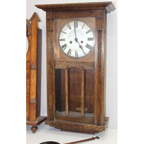 1309 - 2 vintage oak wall clocks, one in Gothic Revival style case, both with pendulums, the largest approx... 