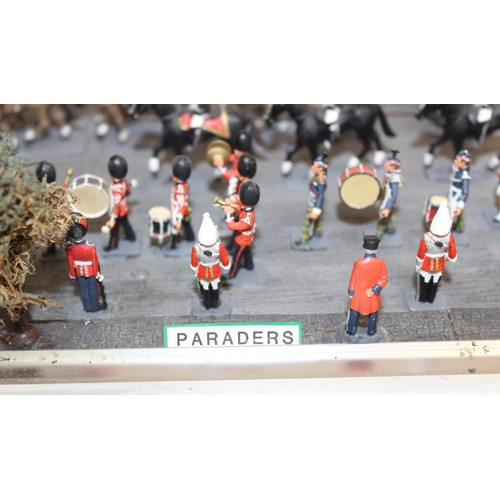 1414 - A trooping of the colour model soldier diorama in perspex glazed case, approx 43cm wide