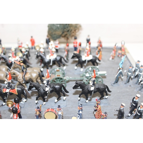 1414 - A trooping of the colour model soldier diorama in perspex glazed case, approx 43cm wide