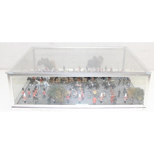 1414 - A trooping of the colour model soldier diorama in perspex glazed case, approx 43cm wide