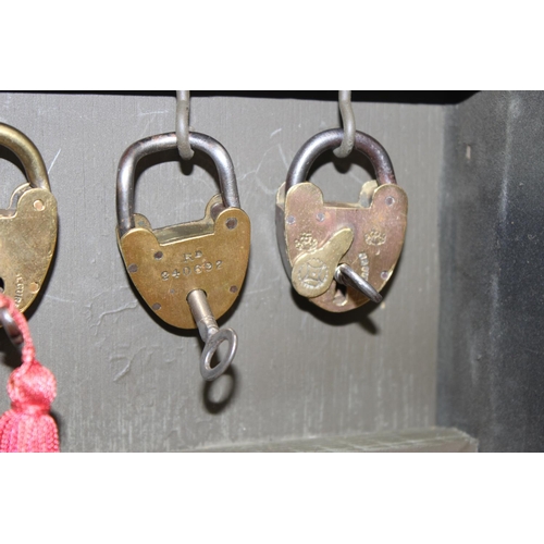 1536 - A cased display of 27 Victorian and early 20th century brass padlocks with keys, various makers and ... 