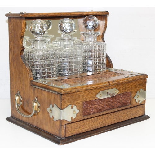 1537 - A 19th century oak 3 bottle tantalus with secret compartment, the body with carved details, approx 3... 