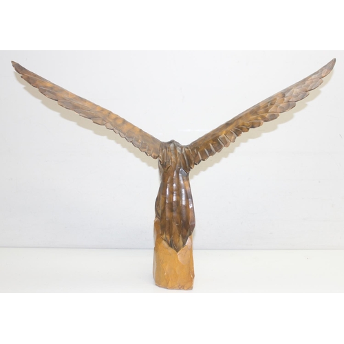 1601 - Vintage chip carved wooden model of an eagle perched on a stump with loose wings, approx 77cm W x 55... 