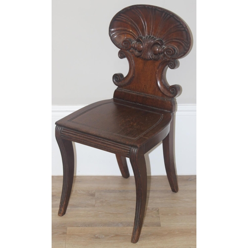 131 - In the manner of Gillows, a 19th century mahogany hall chair with shell shaped carved back, approx 8... 