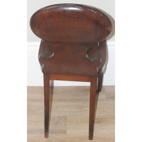 131 - In the manner of Gillows, a 19th century mahogany hall chair with shell shaped carved back, approx 8... 