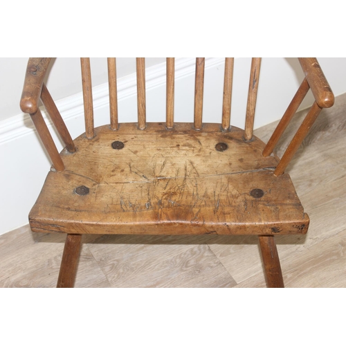 136 - An unusual antique stick back chair with elm seat, possibly a Welsh yoke backed chair, 19th century ... 