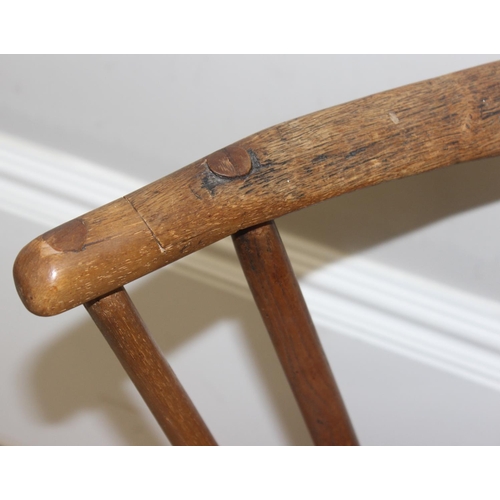 136 - An unusual antique stick back chair with elm seat, possibly a Welsh yoke backed chair, 19th century ... 